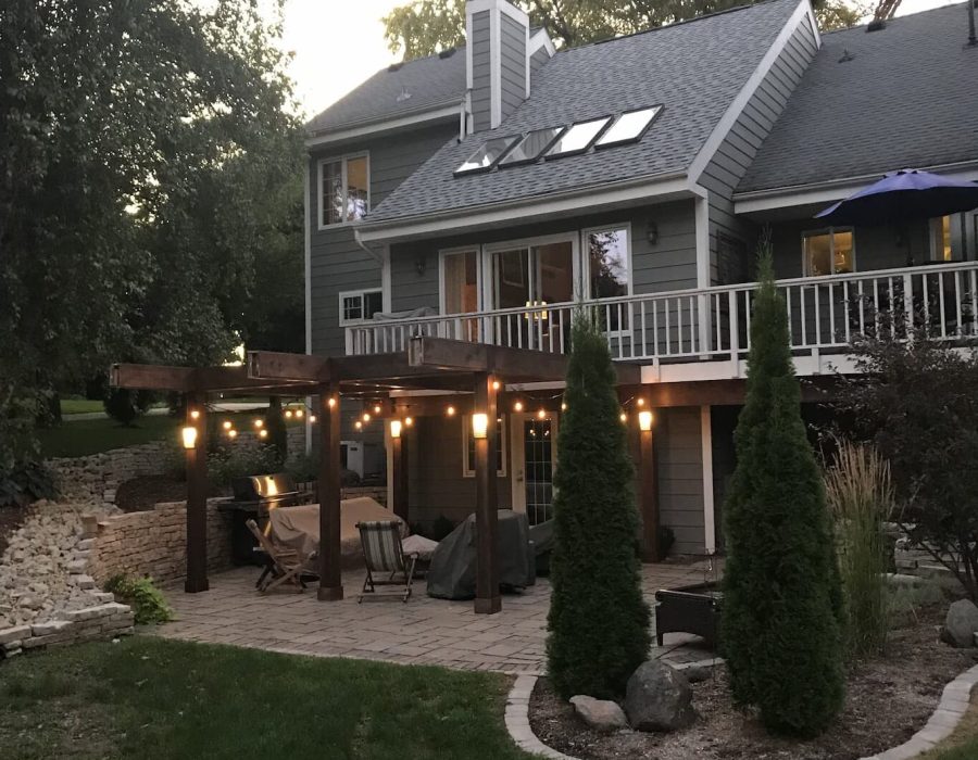 IMG_0349 Cozy backyard with deck and string lights at dusk.